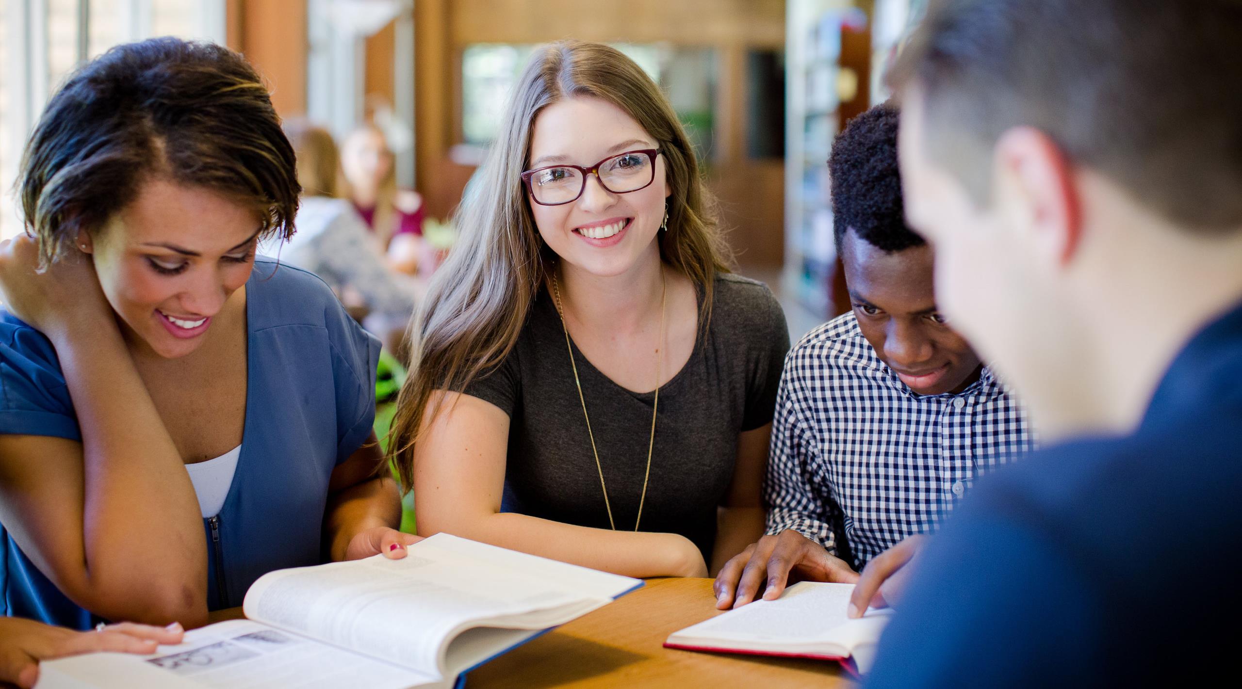 4 College of the Ozarks students working on classwork together